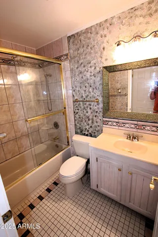 a bathroom with a granite countertop sink toilet a mirror and shower