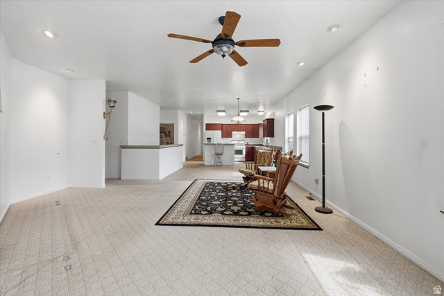 560 East 700 North Logan, UT 84321 - Photo 7 of 32 Open-concept living area with neutral carpeting and recessed lighting