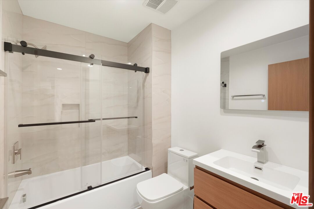 11025 1/2 Blix Street North Hollywood, CA 91602 - Photo 13 of 18 a bathroom with a sink toilet and shower