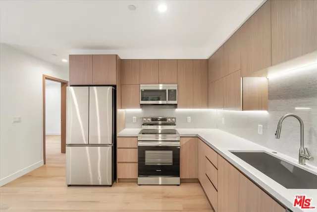 a view of kitchen with stainless steel appliances refrigerator oven and stove