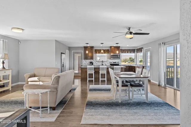 a living room with stainless steel appliances kitchen island granite countertop furniture and a kitchen view
