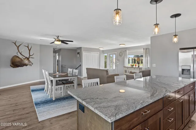 a view of kitchen island with granite countertop living room