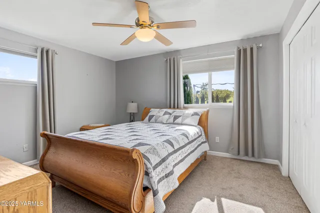 a bed sitting in a bedroom next to a window