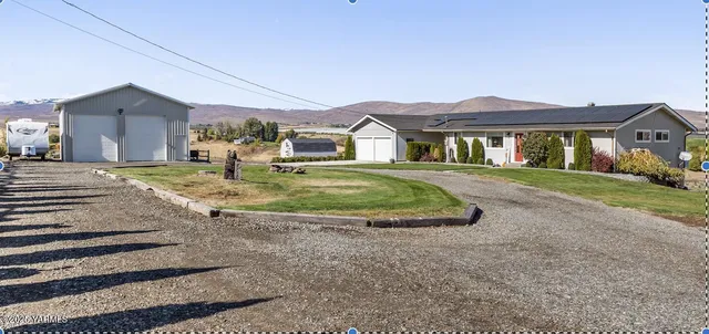 a view of a big house with a big yard and potted plants
