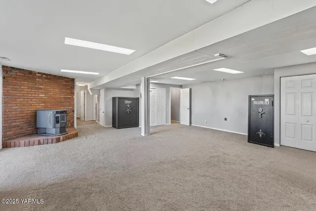 a view of an empty room with furniture and a fireplace