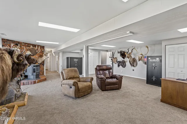 a living room with furniture and a gym machine