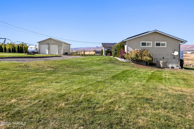 a front view of house with yard and car parked