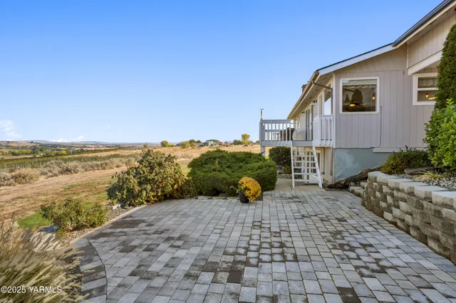 a view of a terrace with lawn chairs
