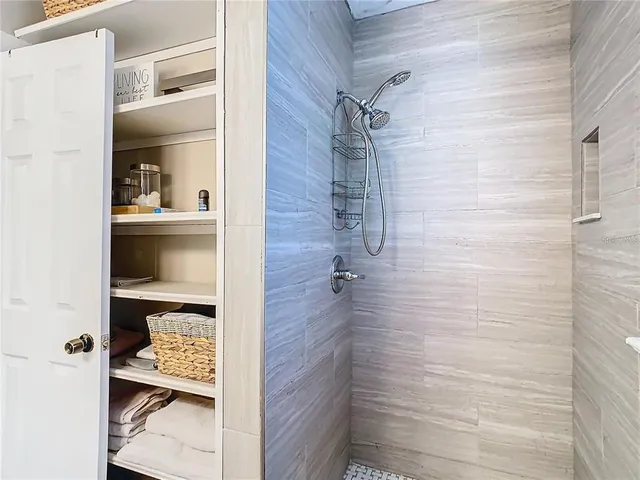 a bathroom with a glass shower door
