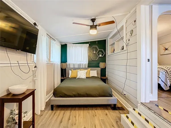 a bedroom with a bed and flat screen tv