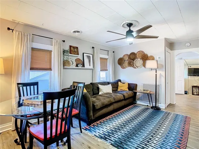 a living room with furniture a ceiling fan and a rug
