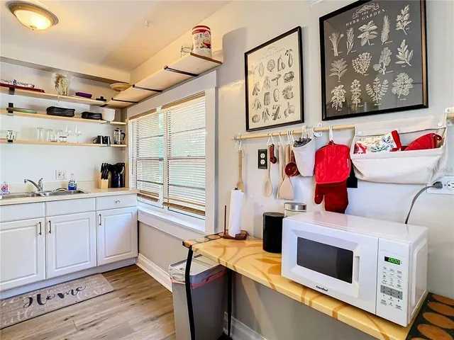 a kitchen with stainless steel appliances kitchen island wooden cabinets and a window