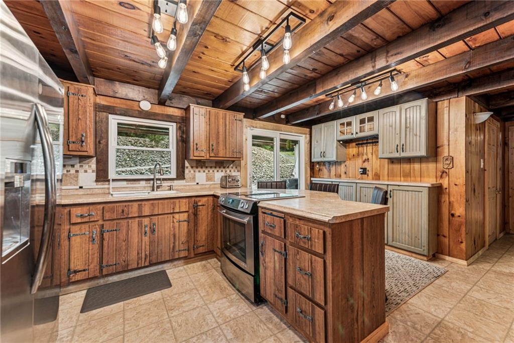 733 McKee Road White Oak, PA 15131 - Photo 16 of 36 a kitchen with stainless steel appliances granite countertop a stove a sink and a refrigerator