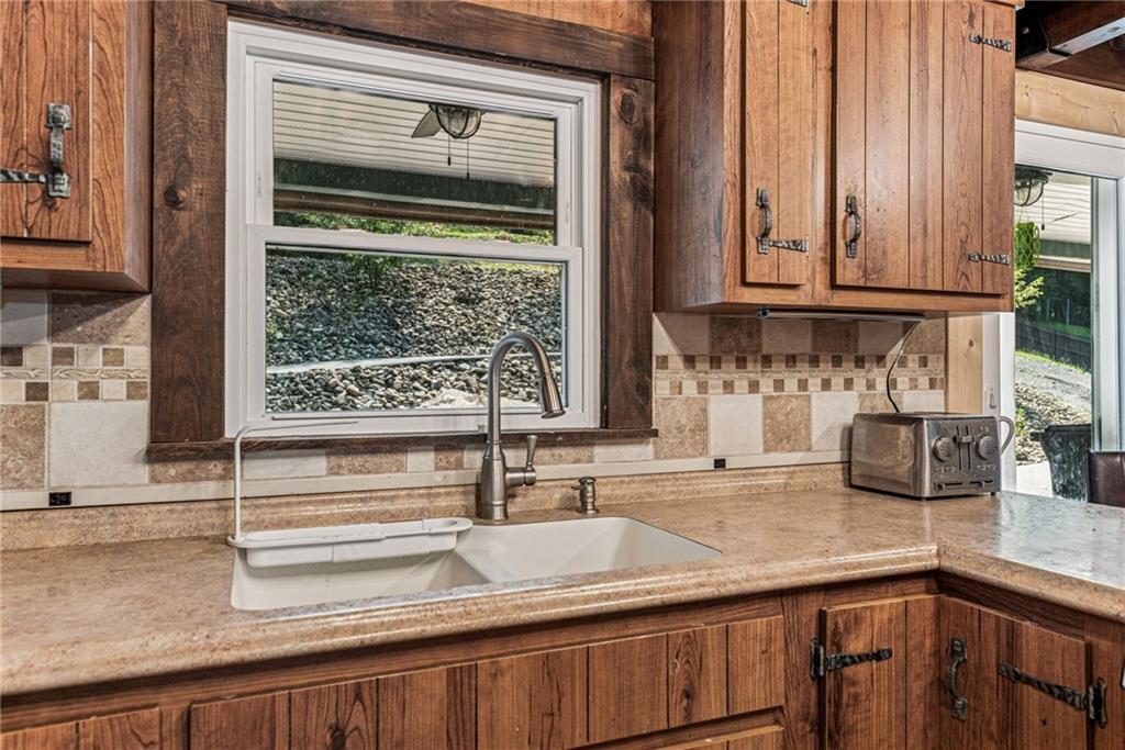 733 McKee Road White Oak, PA 15131 - Photo 18 of 36 a kitchen with granite countertop a sink and a window