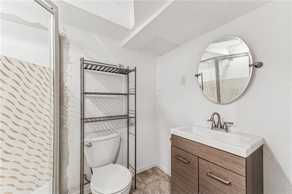 733 McKee Road White Oak, PA 15131 - Photo 27 of 36 a bathroom with a toilet a sink and mirror