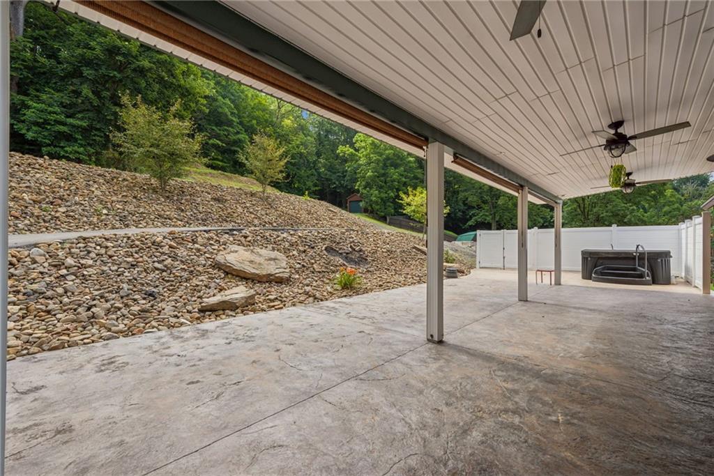 733 McKee Road White Oak, PA 15131 - Photo 30 of 36 a view of a patio with table and chairs with wooden fence