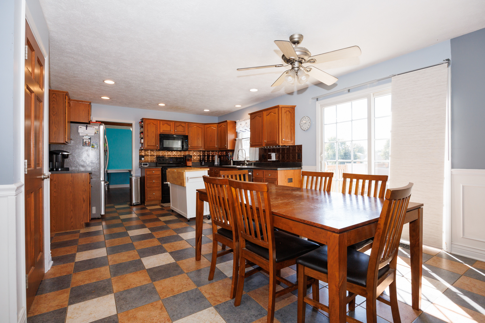 2405 Savanna Road Bloomington, IL 61705 - Photo 13 of 48 a kitchen with stainless steel appliances kitchen island granite countertop a table chairs and a refrigerator