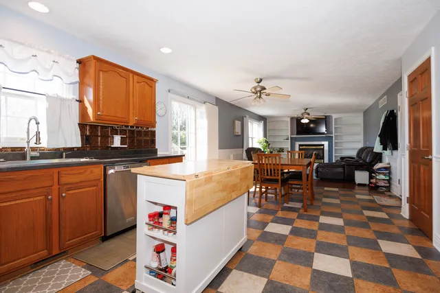 a very nice looking living room with a black and white kitchen