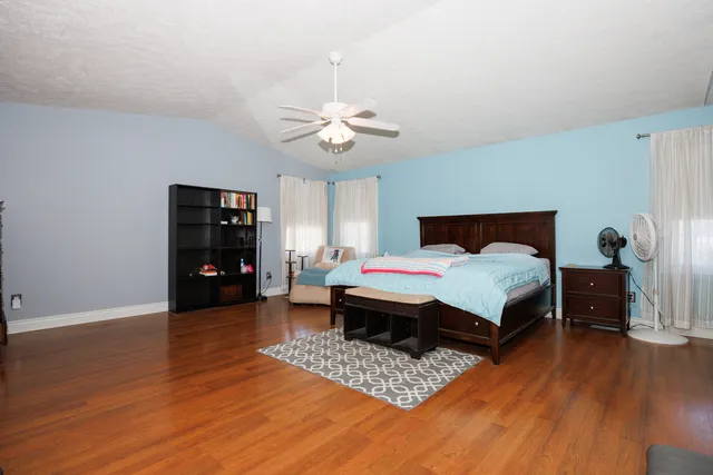 a bedroom with a bed and a chandelier