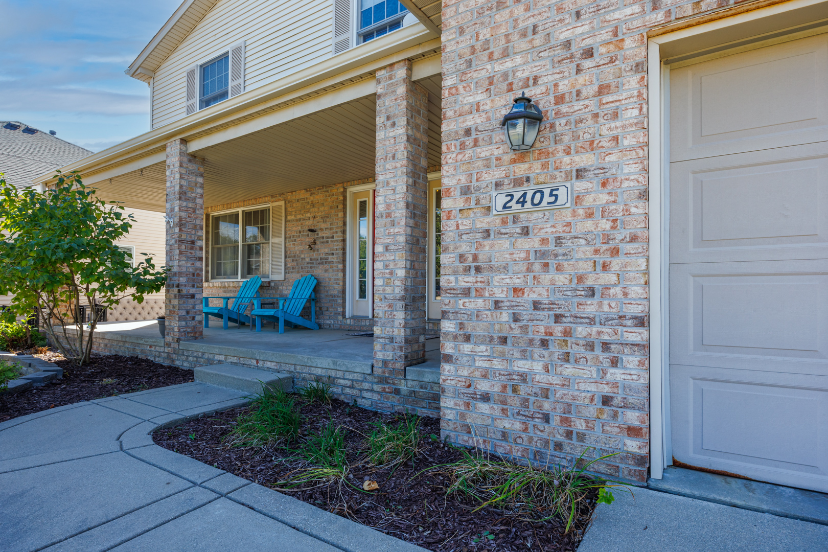 2405 Savanna Road Bloomington, IL 61705 - Photo 2 of 48 a view of a brick house with potted plants