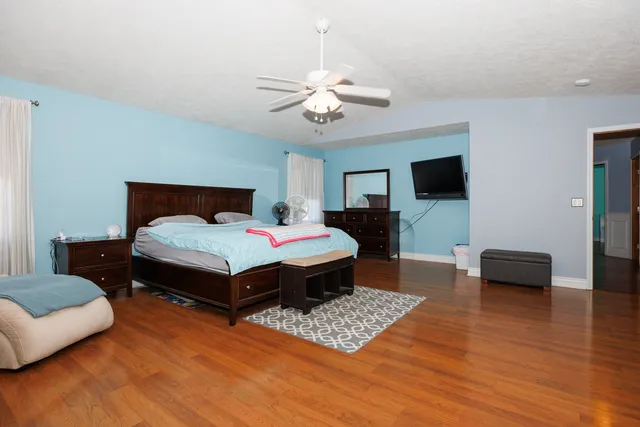 a bedroom with furniture and a wooden floor