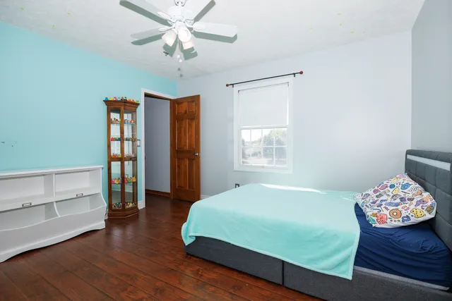 a bedroom with a bed and a chandelier