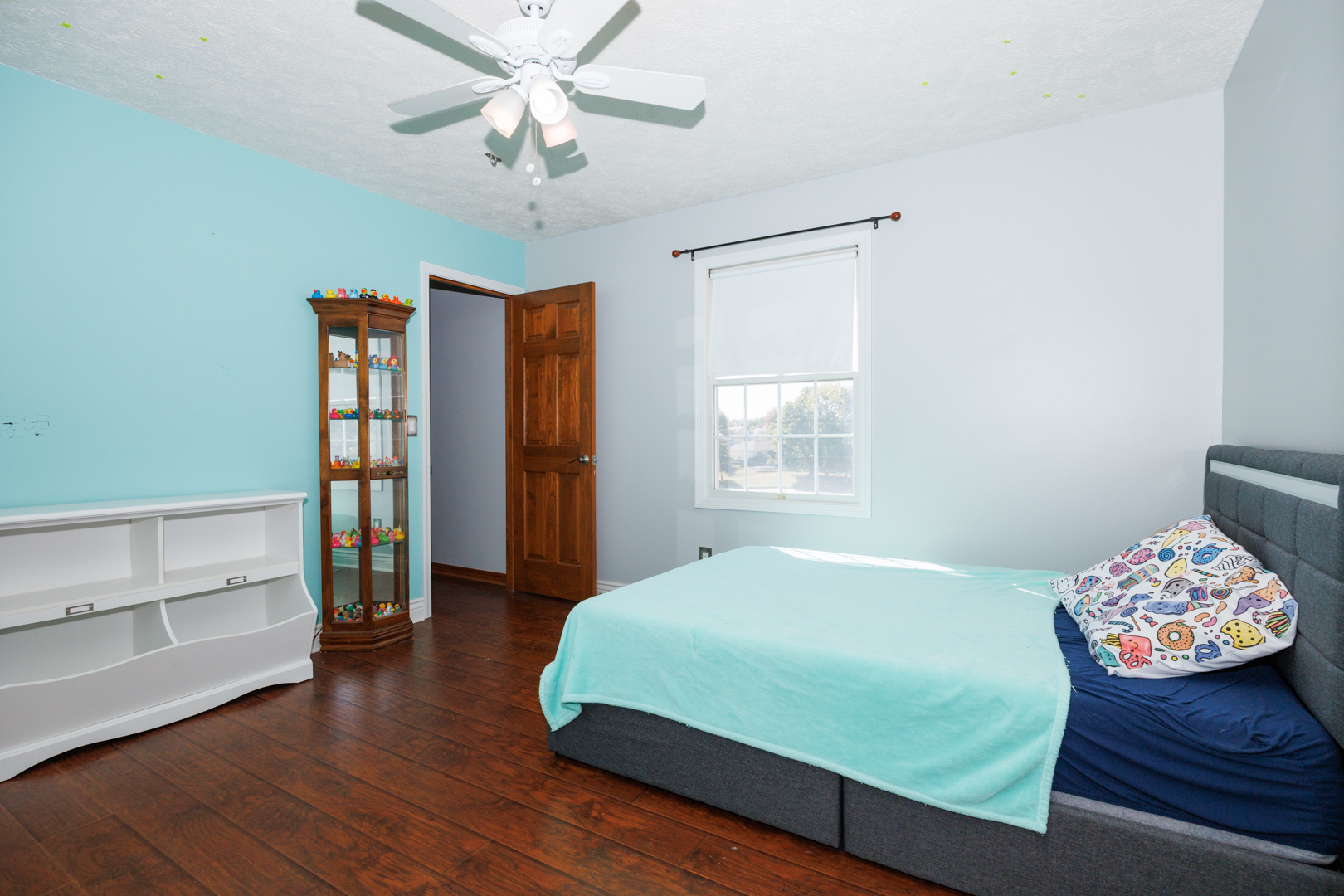 2405 Savanna Road Bloomington, IL 61705 - Photo 27 of 48 a bedroom with a bed and a chandelier