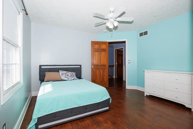a bedroom with a bed and a chandelier