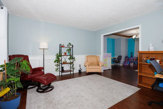 a living room with furniture and a lamp