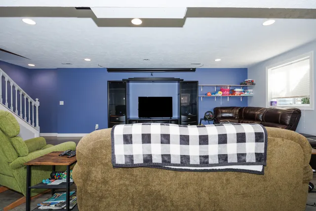 a living room with furniture fireplace and flat screen tv