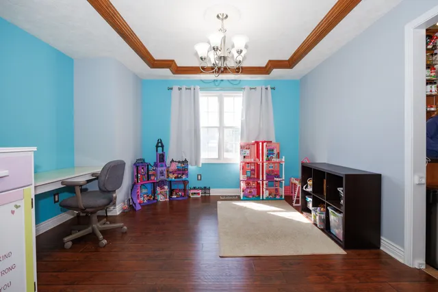 a living room with furniture and a chandelier