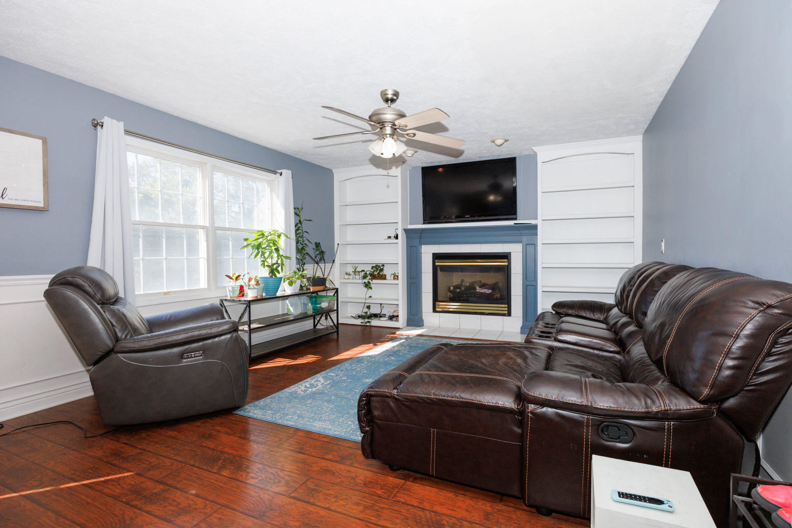 2405 Savanna Road Bloomington, IL 61705 - Photo 9 of 48 a living room with furniture a flat screen tv and a fireplace