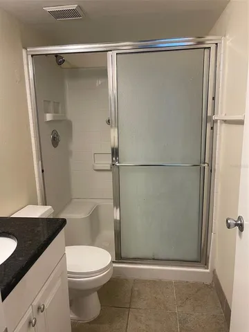 a white toilet sitting next to a bathroom sink