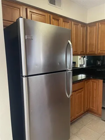 a view of a refrigerator in kitchen