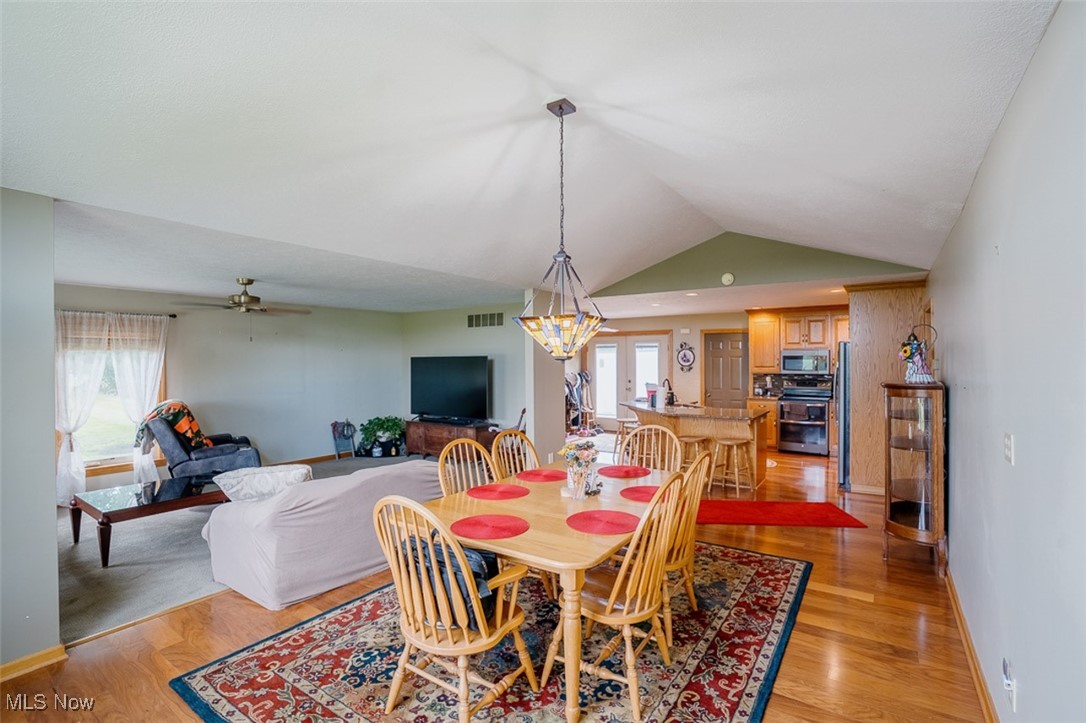 36328 Eagleton Road Lisbon, OH 44432 - Photo 18 of 49 Dining space with vaulted ceiling, light wood-style floors, and ceiling fan