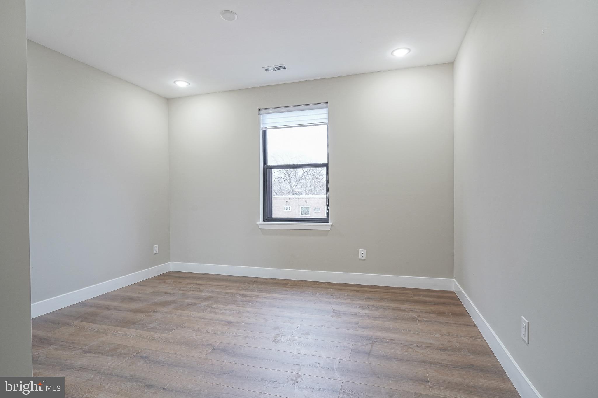 4432-00 Wingate Street, Unit 104 Philadelphia, PA 19136 - Photo 26 of 32 wooden floor in an empty room with a window
