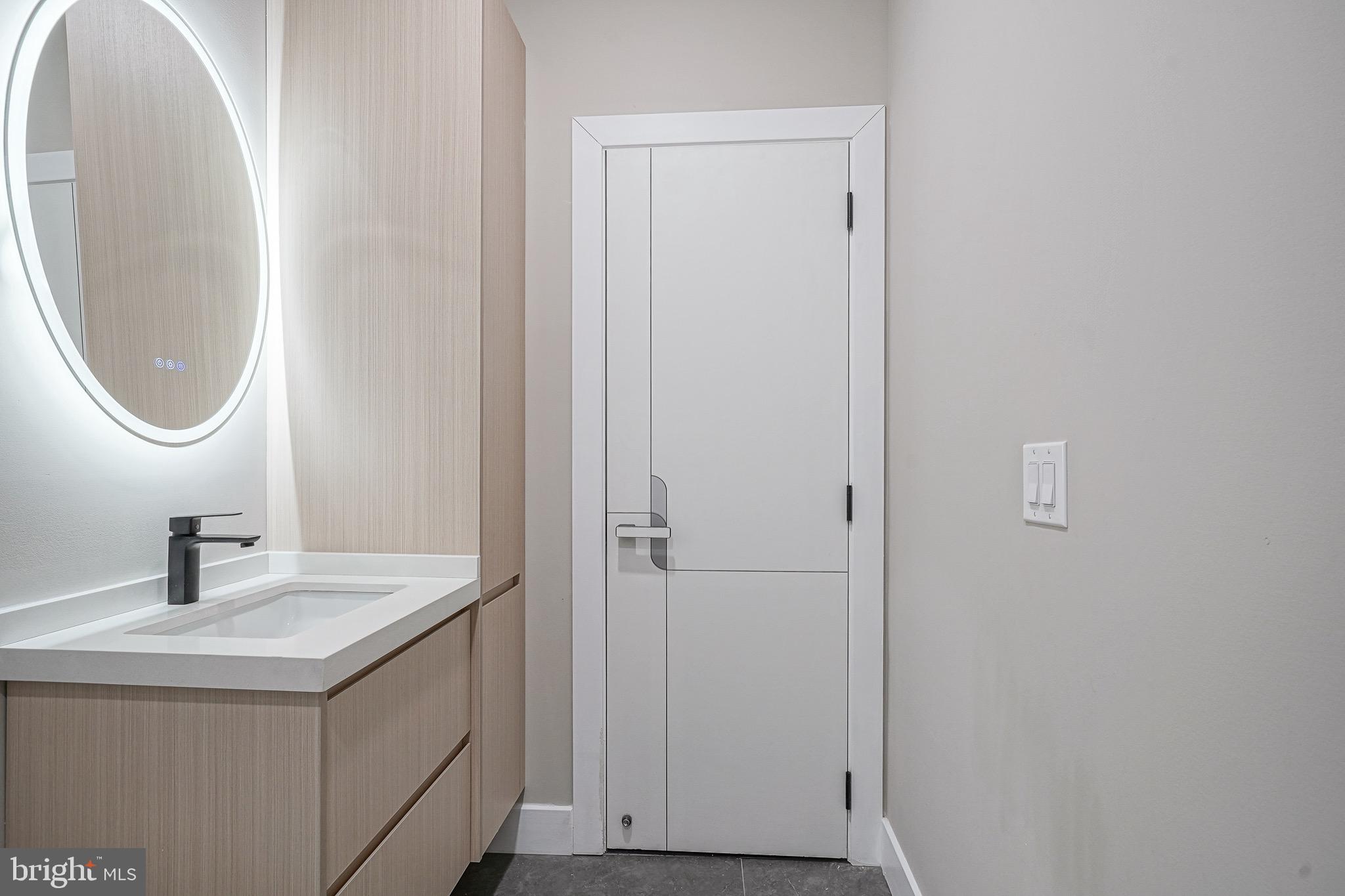 4432-00 Wingate Street, Unit 104 Philadelphia, PA 19136 - Photo 30 of 32 a bathroom with a sink and a mirror