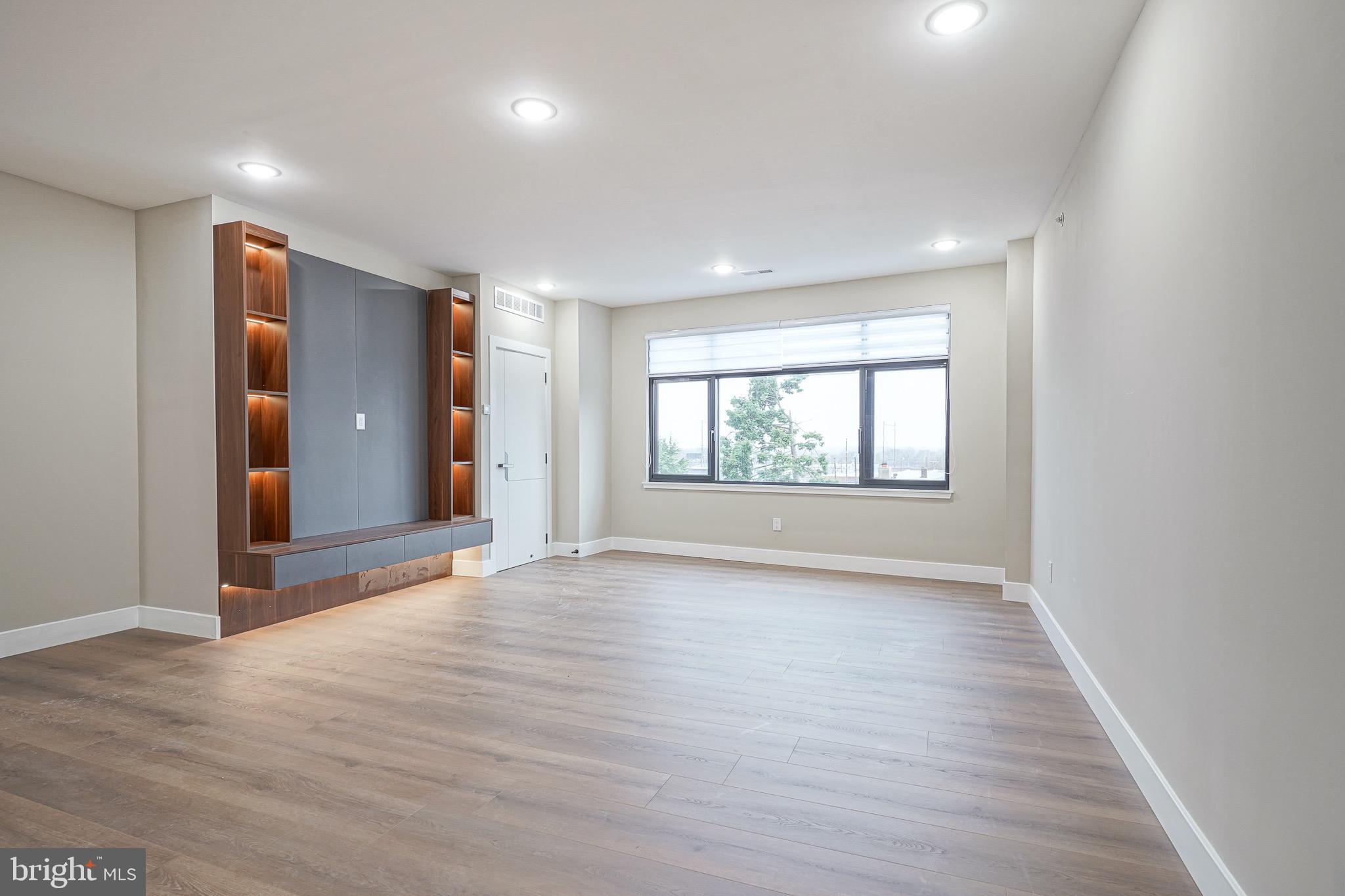4432-00 Wingate Street, Unit 104 Philadelphia, PA 19136 - Photo 10 of 32 an empty room with wooden floor and windows