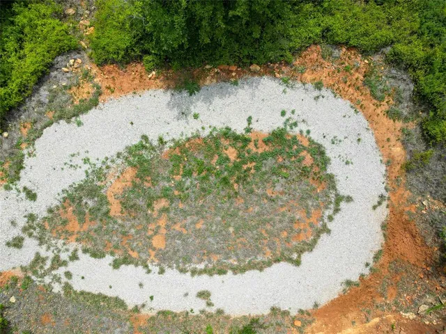 a view of a lake in between of trees