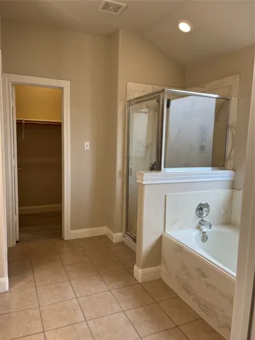 a bathroom with a bathtub sink and mirror
