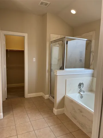 a bathroom with a bathtub sink and mirror
