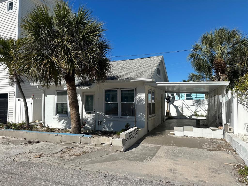 36 80th Terrace Treasure Island, FL 33706 - Photo 1 of 1 a front view of a house with a yard and garage