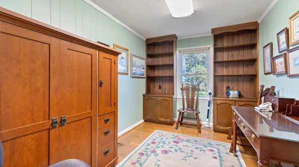 a living room with furniture a rug and a window