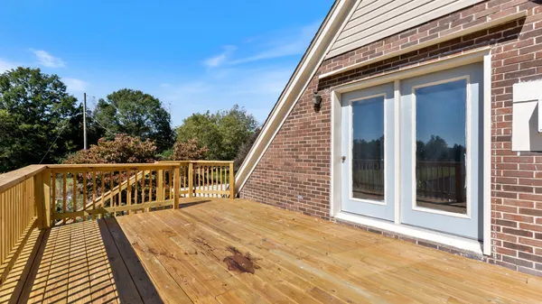 a view of balcony with wooden floor and fence