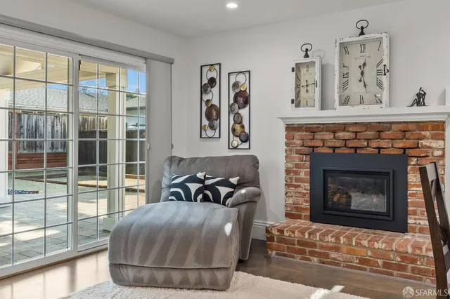 a living room with furniture a large window and a fireplace