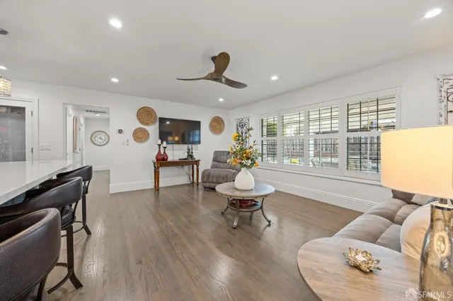 a living room with furniture and wooden floor