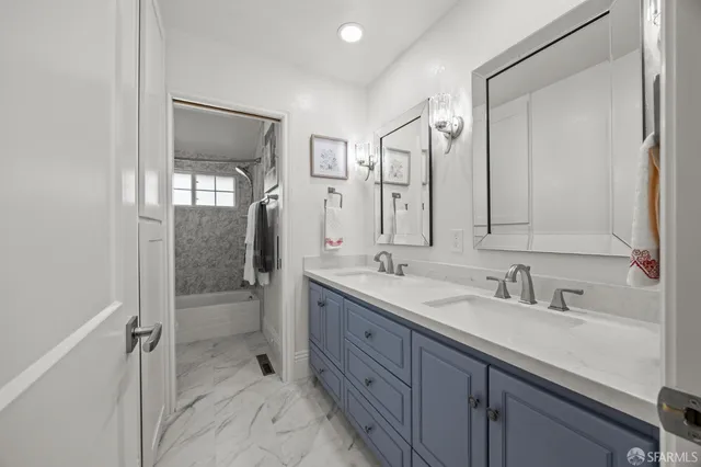 a bathroom with a granite countertop bathtub shower and toilet