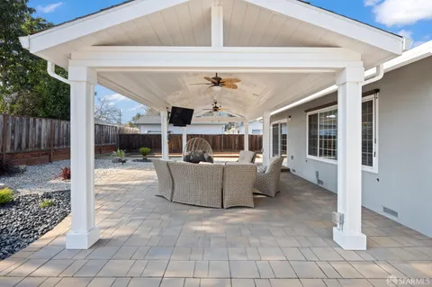 a view of a patio with a table and chairs