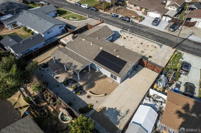 an aerial view of a residential building with parking