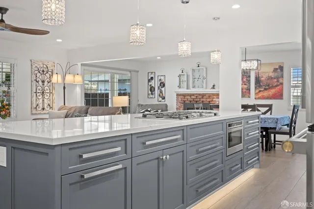 a kitchen with granite countertop white cabinets and white appliances